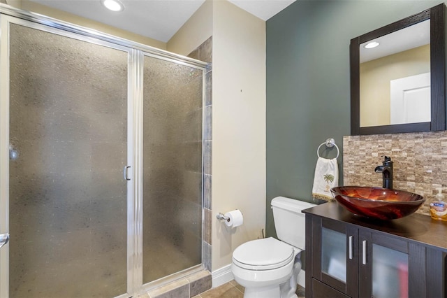 bathroom featuring an enclosed shower, tile floors, vanity, tasteful backsplash, and toilet