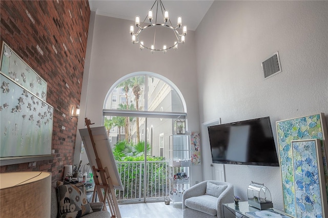 living room featuring hardwood / wood-style floors, high vaulted ceiling, and a notable chandelier