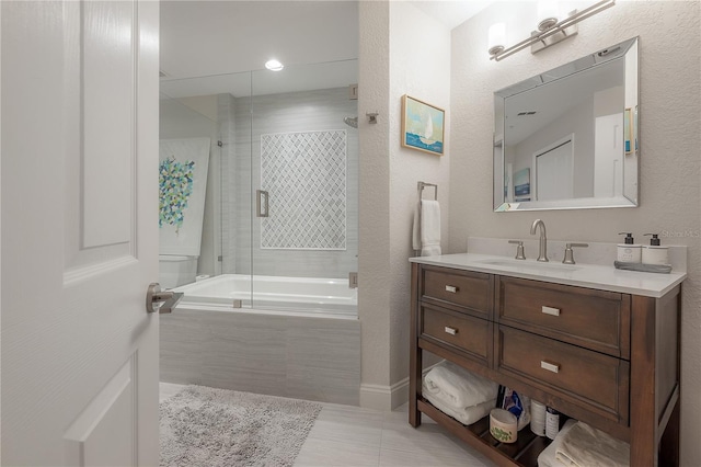 bathroom featuring vanity, tile floors, and enclosed tub / shower combo