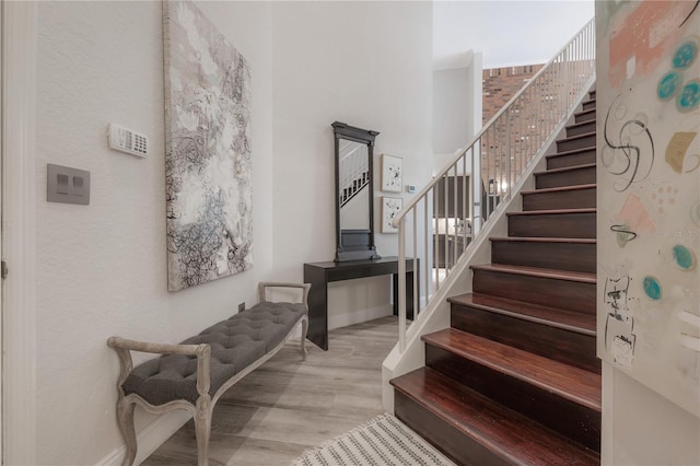 staircase with light hardwood / wood-style floors