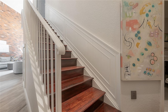 staircase featuring light wood-type flooring