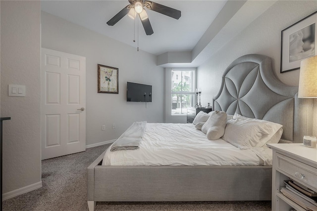 bedroom with dark colored carpet and ceiling fan