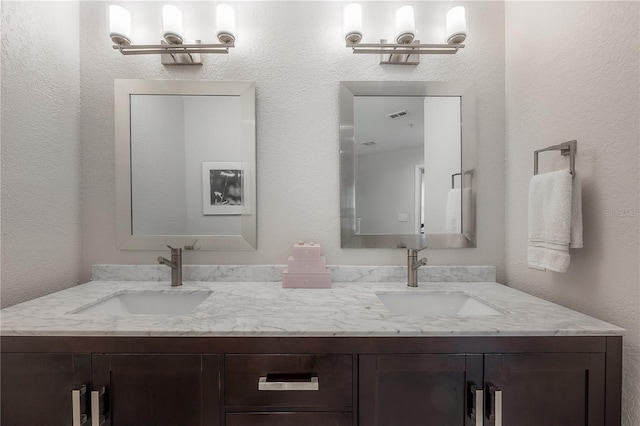 bathroom with vanity with extensive cabinet space and dual sinks