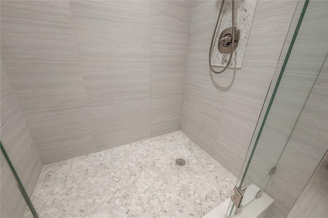 bathroom with tiled shower