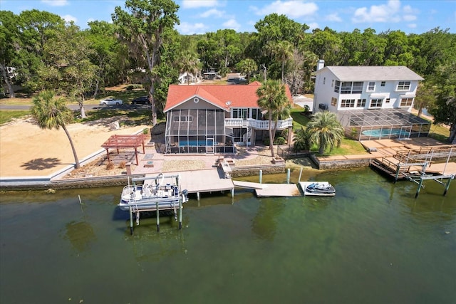 dock area featuring a water view, a pool, and a patio