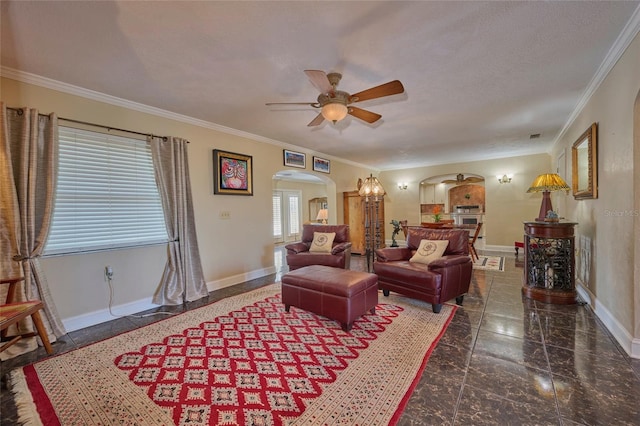 living room featuring crown molding, ceiling fan, and a textured ceiling