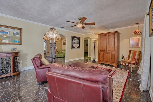 living room with ceiling fan, ornamental molding, and a textured ceiling