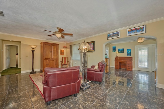 living room with ceiling fan, a textured ceiling, and ornamental molding