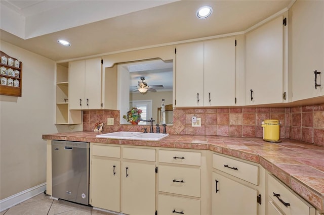 kitchen with dishwasher, cream cabinets, backsplash, and sink