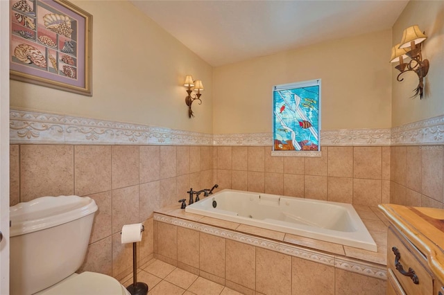 bathroom featuring tile patterned flooring, tiled bath, toilet, and tile walls