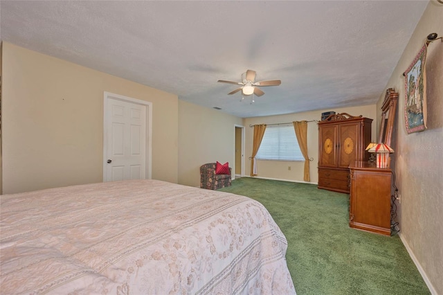 bedroom with ceiling fan, a textured ceiling, and dark colored carpet