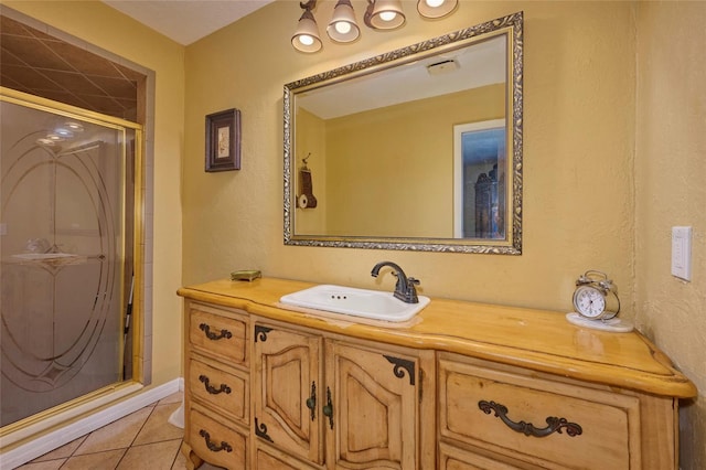 bathroom with tile patterned floors, vanity, and an enclosed shower