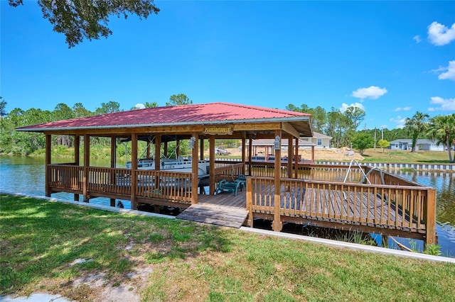 view of dock with a water view and a lawn