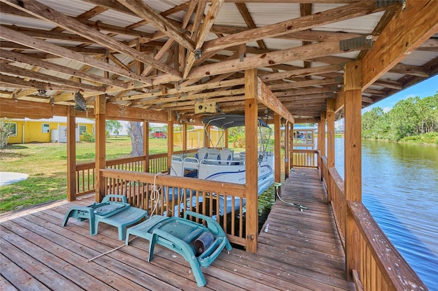 view of dock featuring a water view and a yard