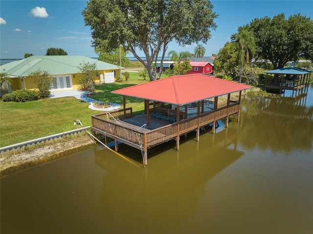 dock area with a water view and a yard