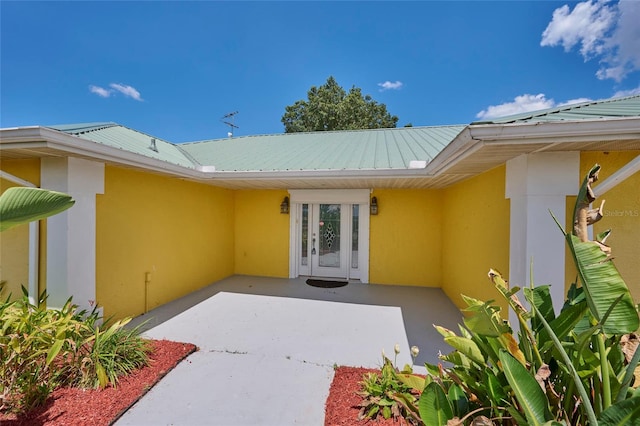 view of exterior entry with a patio