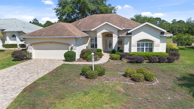 single story home featuring a garage and a front yard