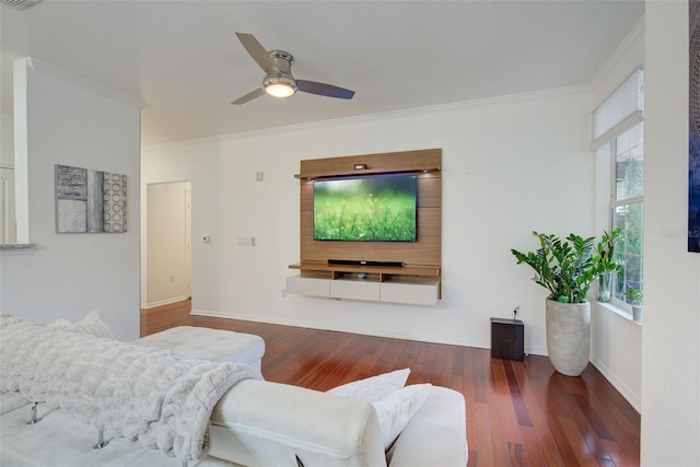 living room with dark wood-type flooring, ceiling fan, and crown molding