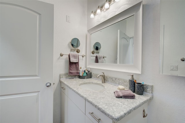 bathroom featuring vanity with extensive cabinet space