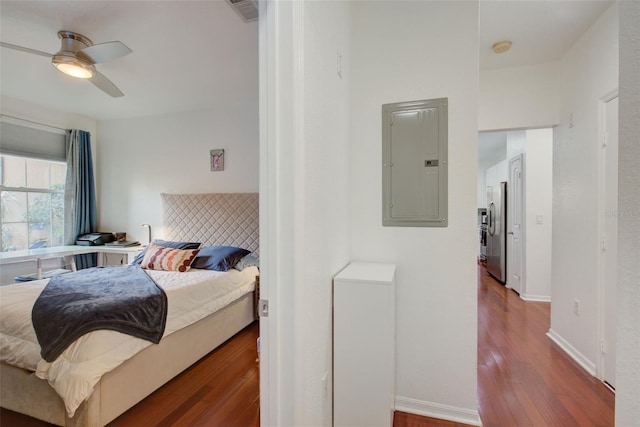 bedroom with ceiling fan, stainless steel fridge, and dark wood-type flooring