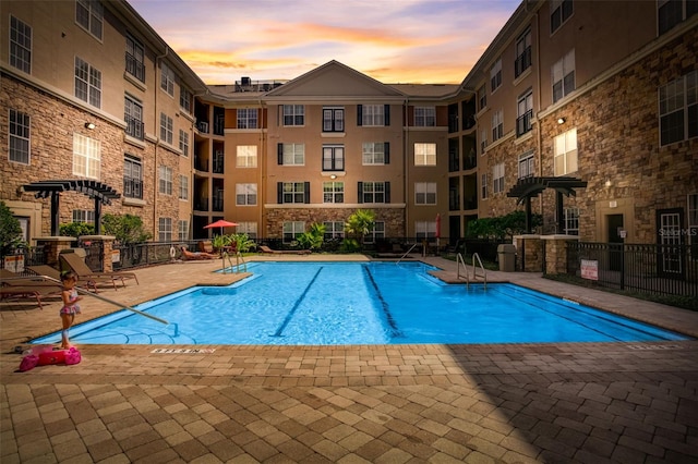 view of pool at dusk