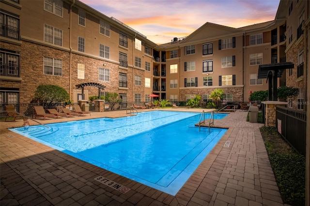 view of pool at dusk