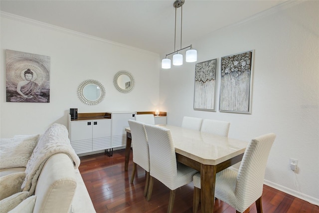 dining room featuring ornamental molding and dark wood-type flooring