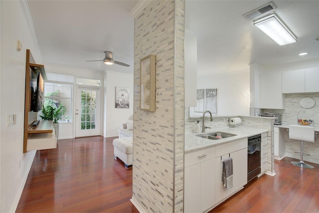 kitchen with light stone countertops, ceiling fan, dark hardwood / wood-style flooring, sink, and white cabinetry