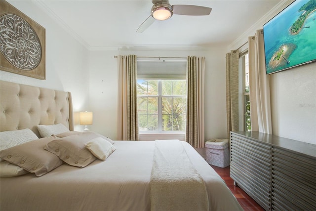 bedroom featuring ceiling fan, crown molding, and dark wood-type flooring