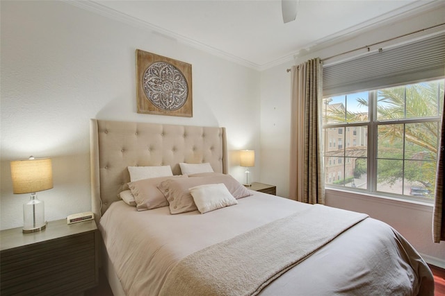 bedroom with hardwood / wood-style flooring, ceiling fan, crown molding, and multiple windows