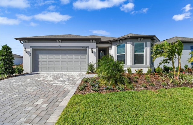 view of front of house featuring a garage and a front lawn