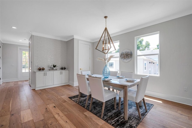 dining area with plenty of natural light, light hardwood / wood-style flooring, and ornamental molding