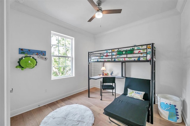 bedroom featuring light wood-type flooring, ceiling fan, and crown molding