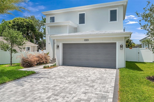 contemporary home with a garage and a front lawn