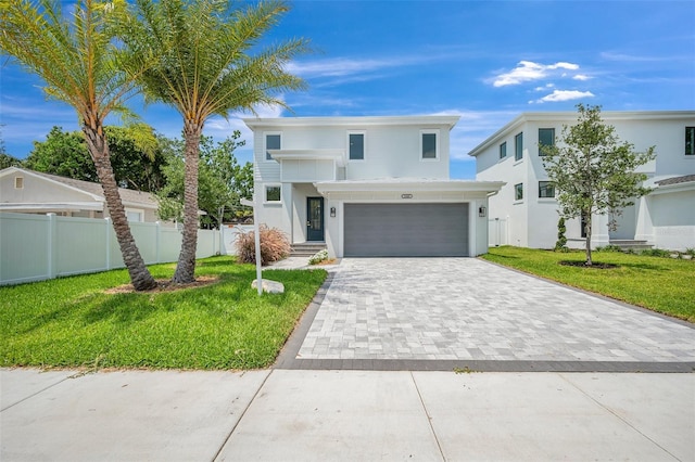 contemporary home featuring a garage and a front lawn