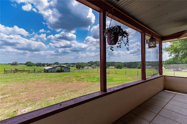 unfurnished sunroom with a rural view