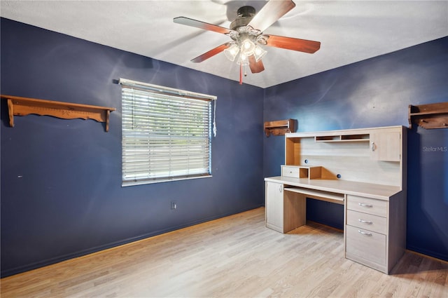 unfurnished office featuring light wood-style flooring and a ceiling fan