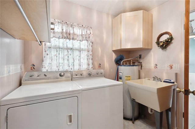 clothes washing area featuring a sink, cabinet space, washing machine and clothes dryer, and electric water heater