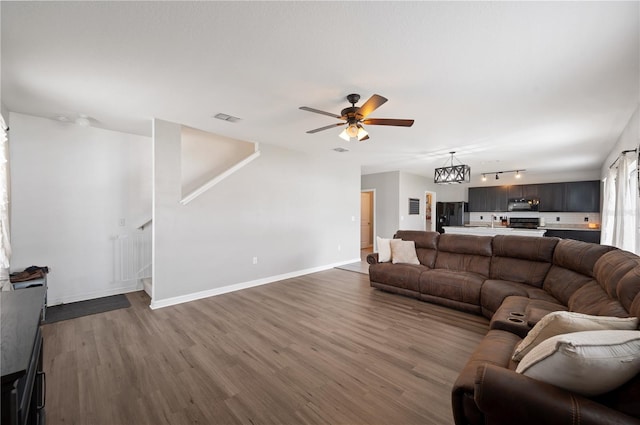 living room with hardwood / wood-style floors and ceiling fan