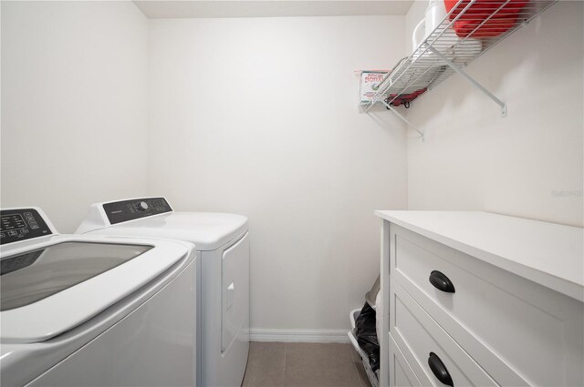 laundry area with independent washer and dryer and tile flooring