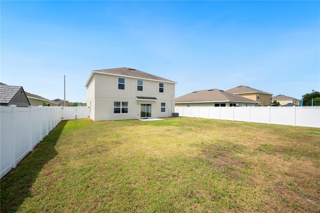 rear view of property with a yard