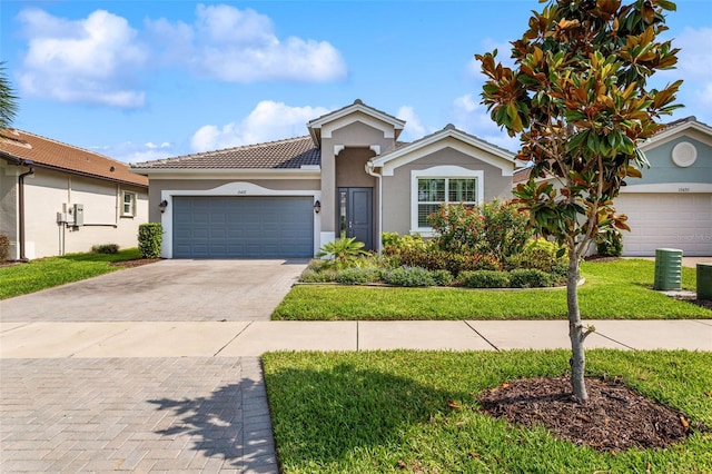 ranch-style home featuring stucco siding, an attached garage, decorative driveway, and a front yard