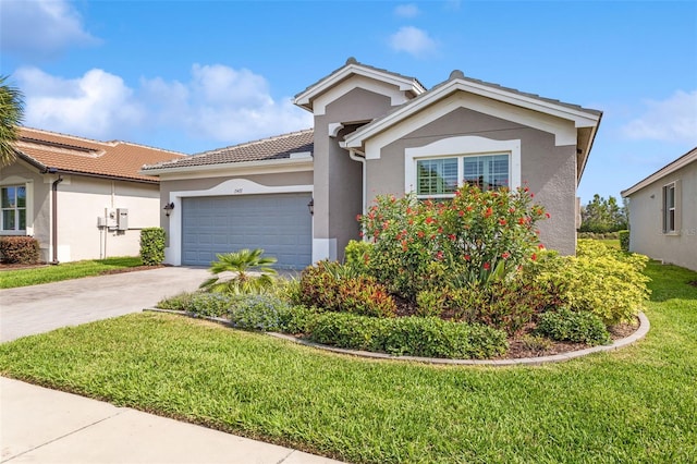 view of front facade with a garage and a front lawn