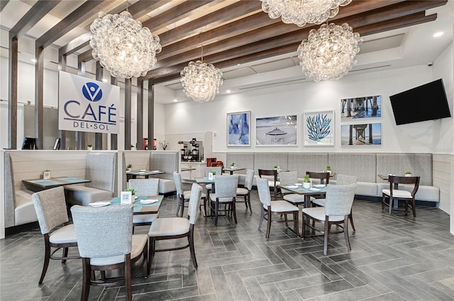 dining room featuring a tray ceiling and an inviting chandelier