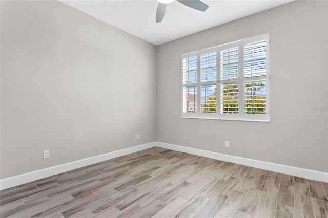 spare room with ceiling fan and light wood-type flooring