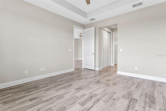 unfurnished bedroom with light wood-type flooring, a closet, and ceiling fan