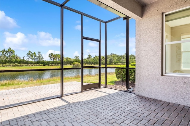 unfurnished sunroom with a water view