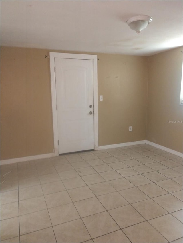 unfurnished room with light tile flooring