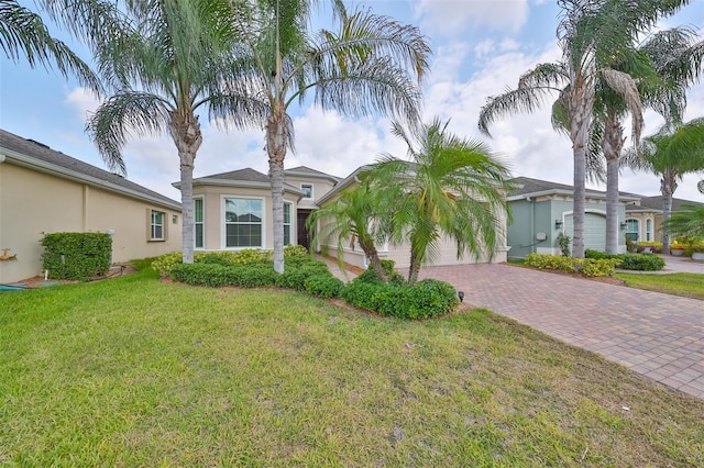 view of front of house with a garage and a front lawn