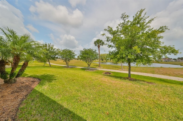 surrounding community featuring a yard and a water view